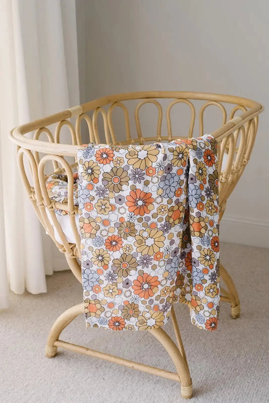 Bloom muslin swaddle wrap hanging on cot