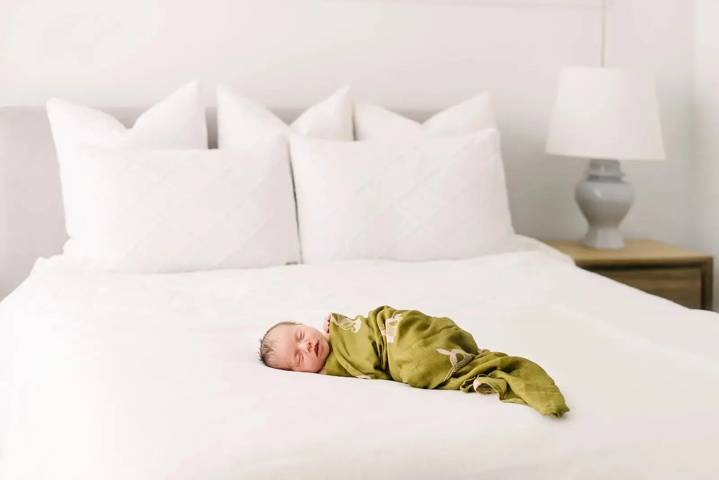 Baby wrapped in Mermaid muslin swaddle wrap while sleeping